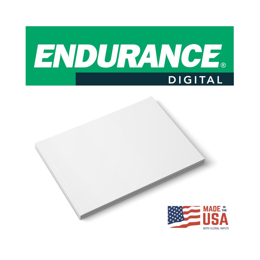 A stack of blank white sheets next to a Made in the USA label and a green digital branding banner. 18X12 100M 120# WHITE ENDURANCE DIGITAL SILK COVER 450/CT 40CT/PL V05759